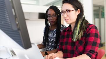 Two women working at a computer