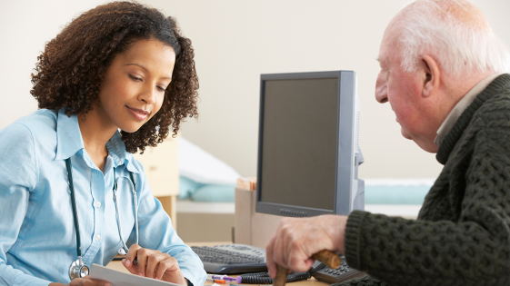 A doctor talking to an older patient.