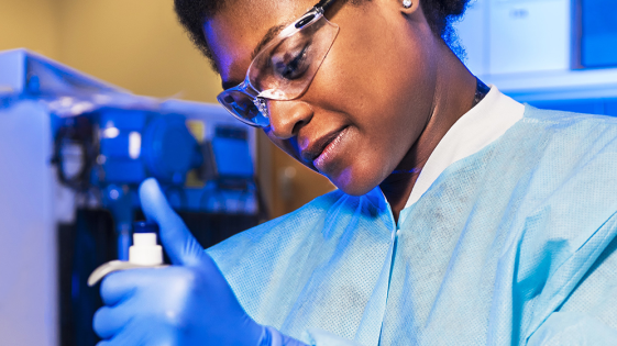 A medical professional preparing a sample.